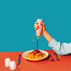 Food pop art photography. Female hands tasting spaghetti with meatballs on plaid tablecloth isolated on bright blue background. Vintage, retro style interior