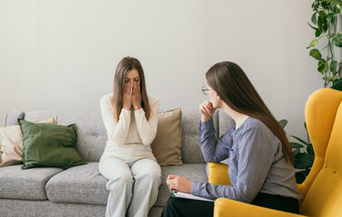 a female psychologist provides psychological assistance to a distressed female patient. Domestic...