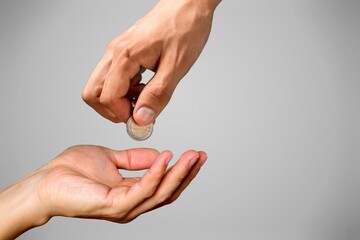 Businessman giving golden bitcoin to another human. two hands exchanging cryptocurrency.