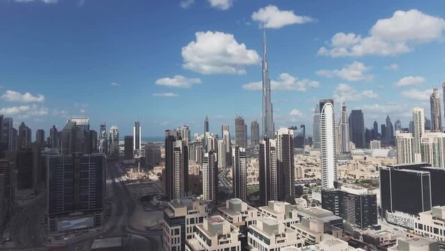 DUBAI, UAE - DECEMBER 8, 2016: Panoramic aerial view of Downtown skyscrapers at sunset, going up in the sky