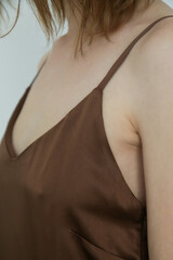Close up of woman wearing brown silk camisole