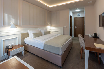 Interior of a luxury hotel double bed bedroom in the evening