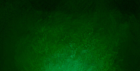 The scuffed green texture of a cement or concrete wall . Dark abstract background with cracks and scuffs