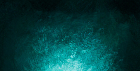 The scuffed blue texture of a cement or concrete wall with a light spot . Dark abstract background with cracks and scuffs