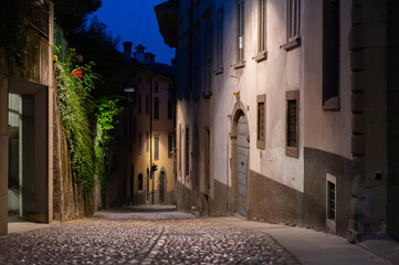 Fototapeta na wymiar Night street without people in Bergamo, Lombardy