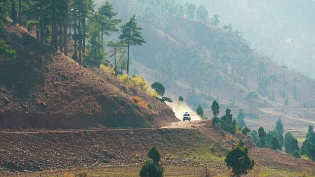 cars leave from behind the mountain and rush along the serpentine. Beautiful mountain landscape
