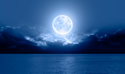 Naklejka na ściany i meble Night sky with full bright moon in the clouds 