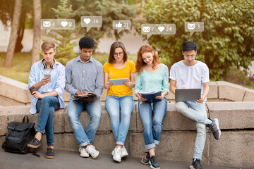 Fototapeta premium Smiling busy diverse students with devices, surfing and chatting at break, checking social networks and online apps