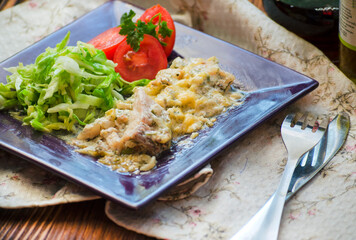 Chicken meat and vegetables on a plate
