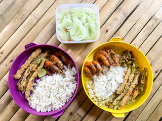 rice with side dish cucumbers, fried prawns and crispy fried beans.