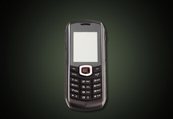 Old retro mobile phone on dark background