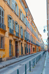 Typical narrow street with orange houses - Aix en Provence, France