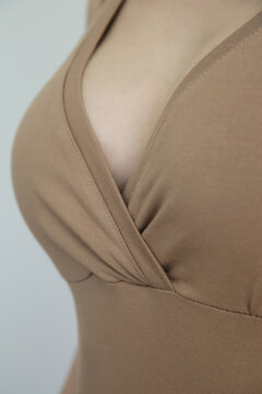 Close Up Of Woman's Decollete, Woman In Beige Cotton V Neck Top