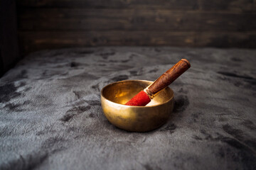 The Singing Bowl and Tibet. Musical instrument of ancient monks. Silence in meditation, yoga at home. The object emitting the gong, vibrations.