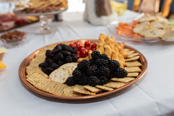 blackberries and crackers on a plate