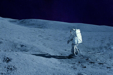 Astronaut on the moon, with galactic background. Elements of this image were furnished by NASA.