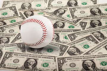 Baseball ball with cash money. Major league strike, lockout and sports betting concept.