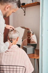 Retirement man getting haircut at home during quarantine