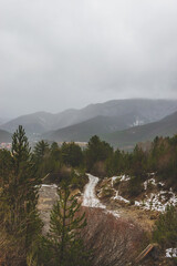 A picturesque landscape view of a hiking path in the French Alps mountains during the rain on a cold winter day (Veynes, Chateauvieux)