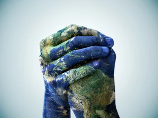 Fotobehang We are the world. A cropped shot of hands painted to look like the earth. © Nathan Christepher Palmer/peopleimages.com