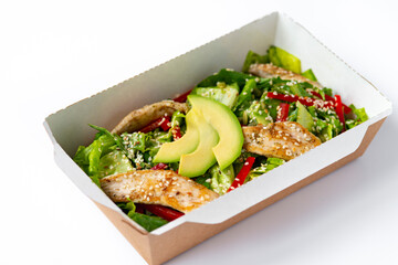 chicken salad with avocado in a Take away box. Healthy lunch