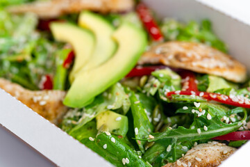 chicken salad with avocado in a Take away box. Healthy lunch
