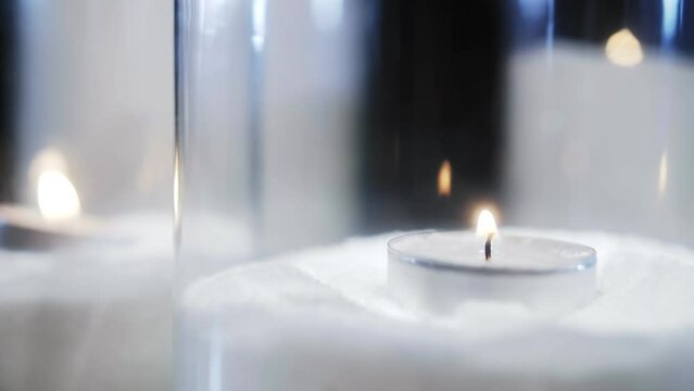 candles burning in glass glasses