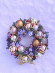 Christmas decorative wreath with pine cones, Christmas tree golden balls and ornaments on a textured background. Toned image in color Very Peri