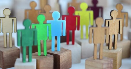 Multi-colored wooden figurines in crowd closeup