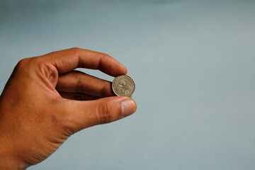 Plakat Close up hand holding twenty cent dollar coin singapore