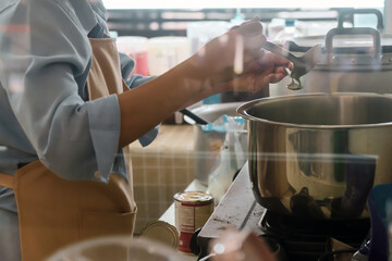 Close up Image of Woman preparing food at the stove