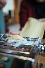 person making home made pasta for ravioli, on the machine 