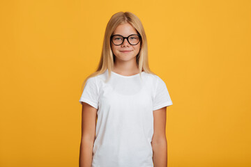 Calm confident pretty european teenager girl in white t-shirt and glasses looking at camera
