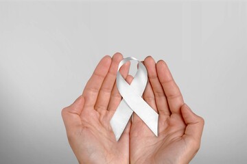 White January, mental health awareness campaign. hand hold a white ribbon.
