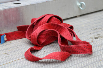 A red cargo strap used in construction sites. Zürich, Switzerland, March 2020.