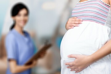 Preparing for baby birth. Woman expecting baby having appointments with doctor at antenatal clinic prenatal healthcare center.