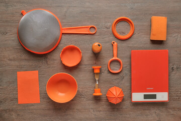 Creative kitchen utensils, nice combination of wood colors and bright orange color. Scales, washing sponge, drushlak, sand chucks, toothpick, magnifying glass, lid, bowl.
