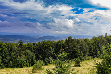 Fototapeta premium Amazing landscape at the mountain top. Panoramic view at mountain valleys lit by sun. Carpathian Mountains