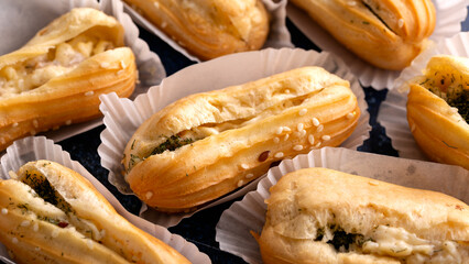 Delicious beautiful dessert profiteroles filled with cheese cream with herbs.
