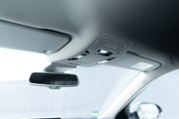 mirror and light control unit on the ceiling of the car