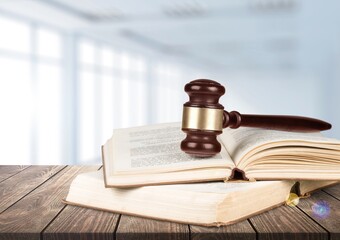 Wooden Judge's gavel on a book on a wooden table. Christian background