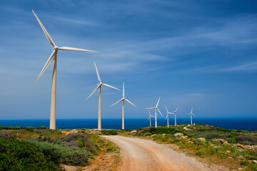 Green renewable alternative energy concept - wind generator turbines generating electricity. Wind...