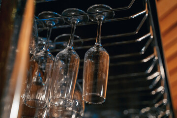 transparent glasses for drinks hang on the bar, nightlife, order