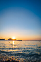Patong Beach sunset in Phuket Island, the most popular beach in the resort town of Phuket island, Thailand.  Patong beach landscape for vacation, holiday, travel 