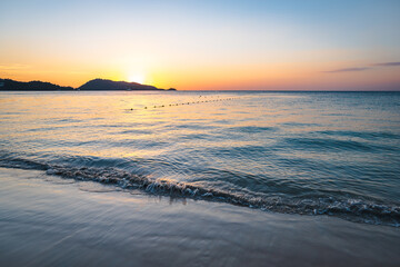 Patong Beach sunset in Phuket Island, the most popular beach in the resort town of Phuket island,...
