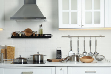 Countertop with different cooking utensils in kitchen
