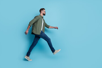 Profile photo of confident tourist guy walk wear eyeglasses green shirt jeans footwear isolated blue color background