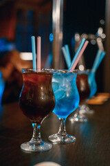 alcoholic cocktails in glasses are on the bar in the institution