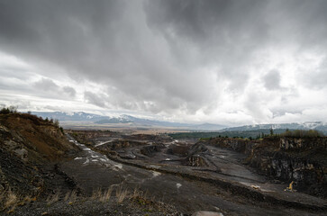 Stone quarry landscape on a cloudy day. Wide image with the stone pit from Liban, Harghita County in Romania.