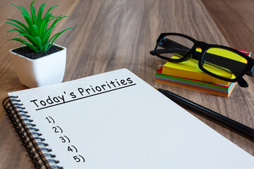 Text on notepad with stationery with potted plan on a desk
